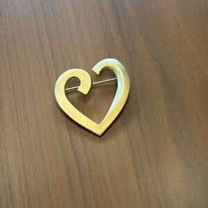 Gold color heart brooch. No brand listed